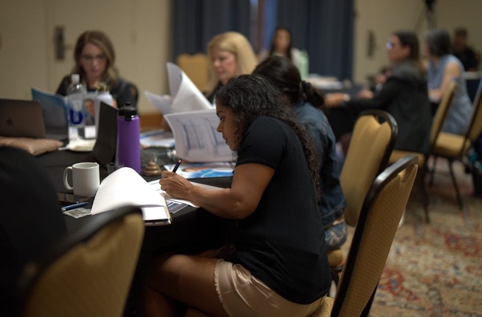 A fellow taking notes during a lecture